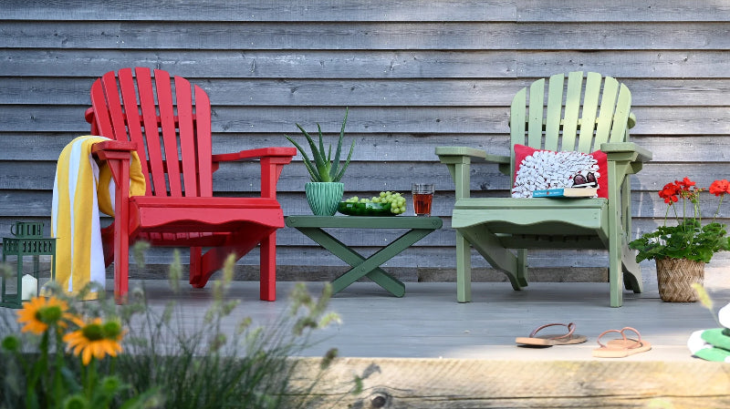 two colourful chairs and table on painted decking